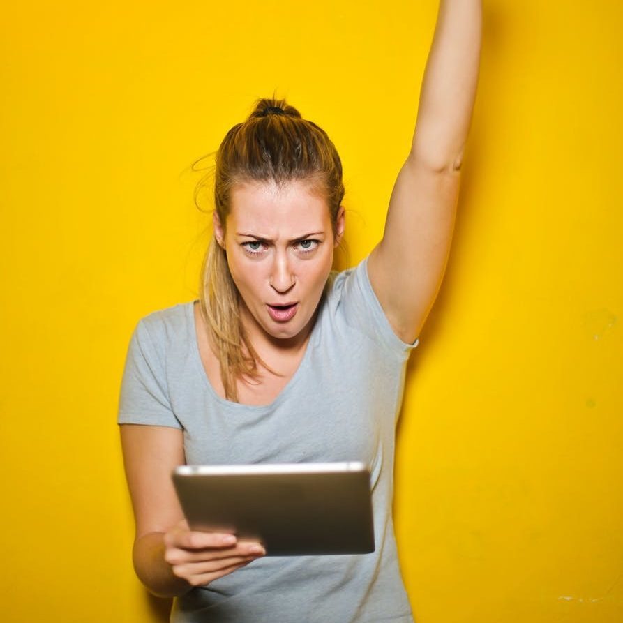 photo of a woman holding an ipad