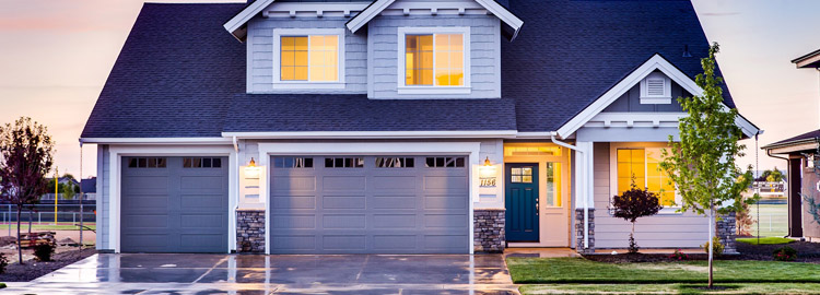 une grande maison avec un jardin et un garage
